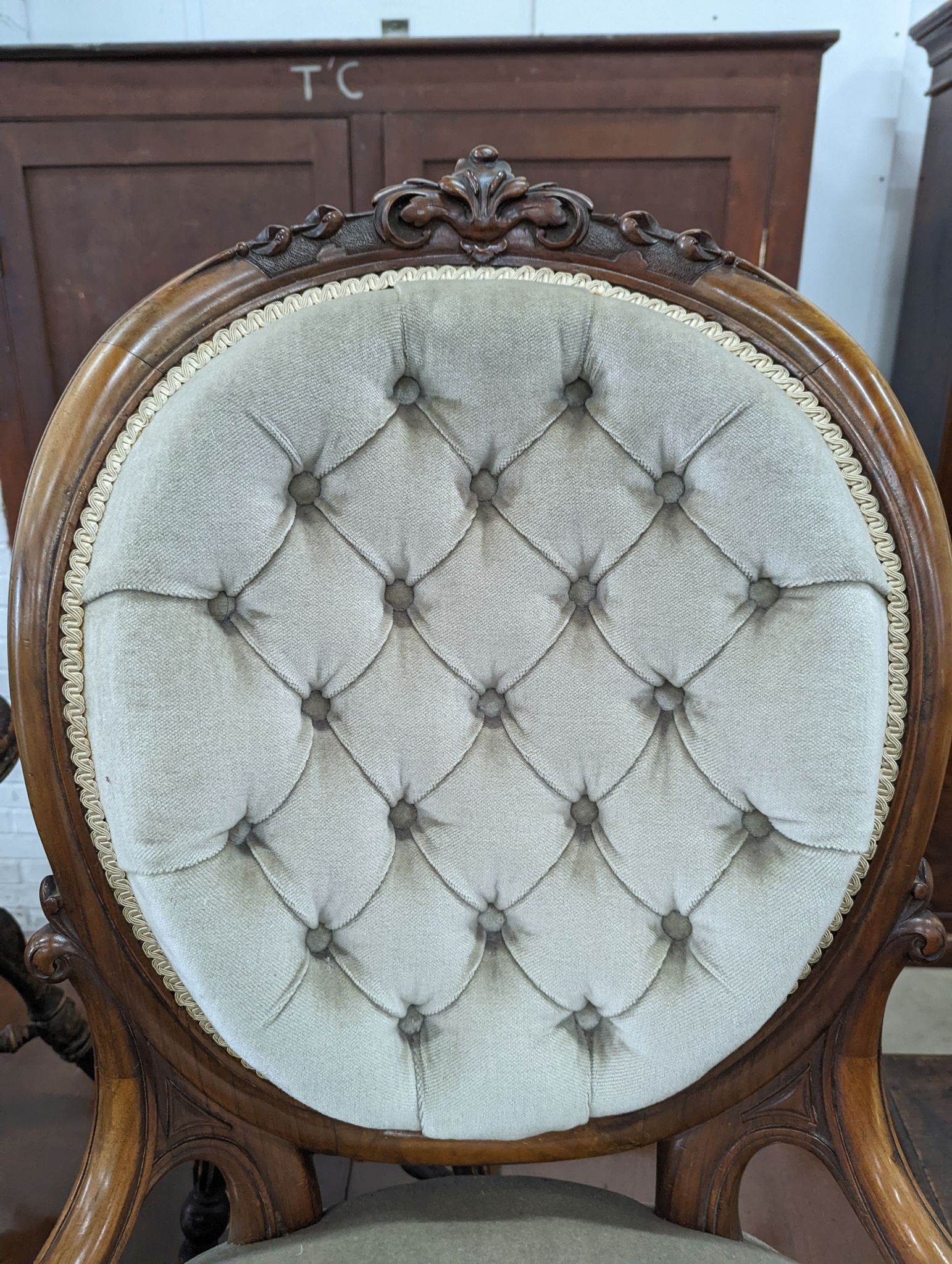A Victorian walnut upholstered spoonback nursing chair